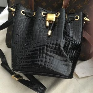 A mini bucket crocodile handbag